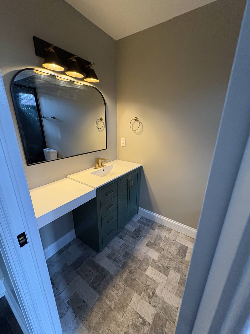 Green vanity with arched mirror