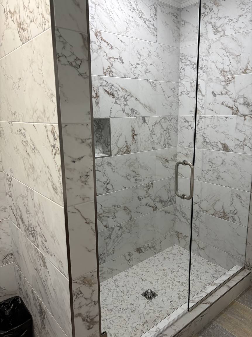 Frameless glass shower with niche